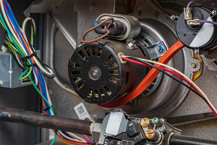 Close-up view of an HVAC furnace blower motor and wiring